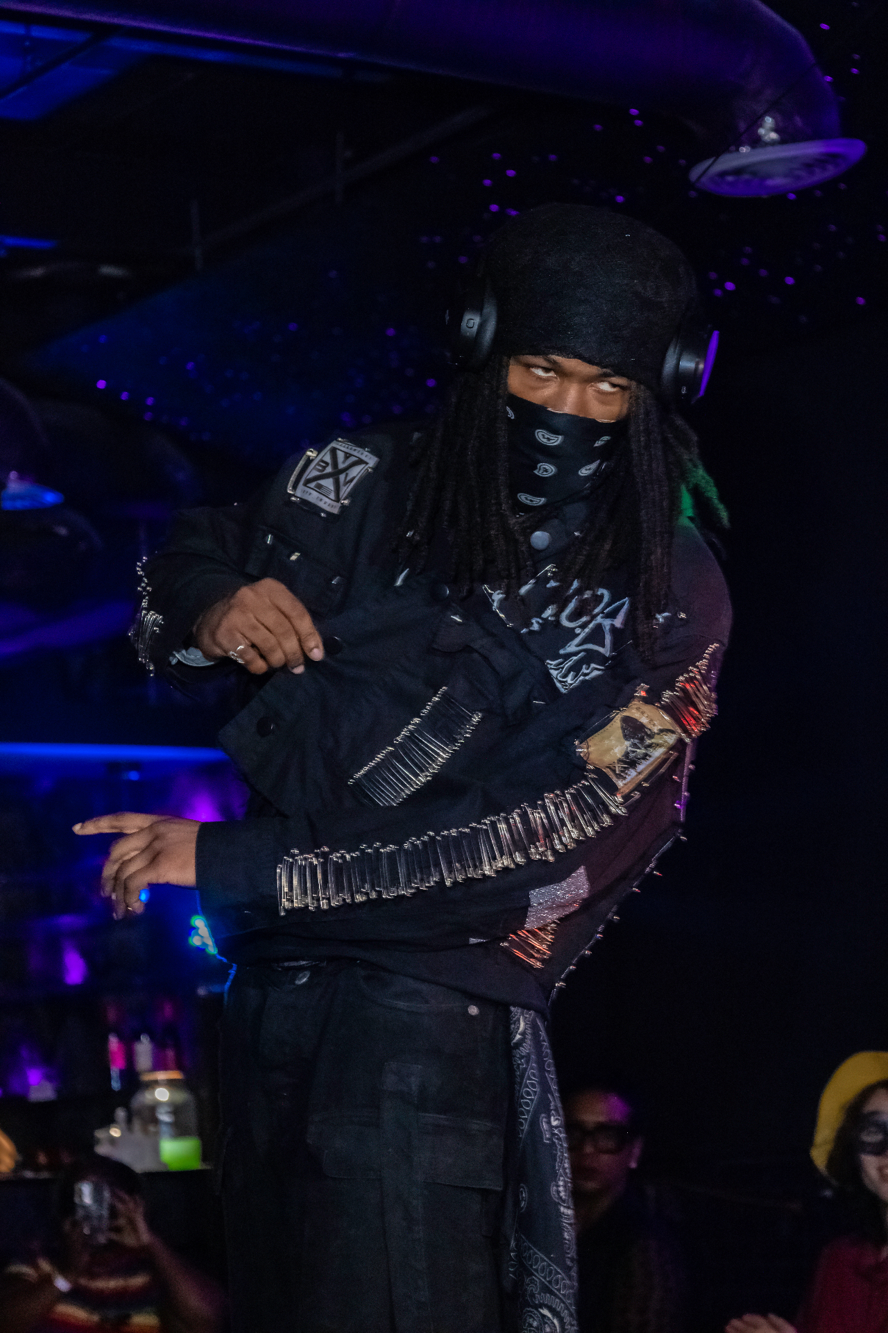 Black safety-pinned jacket performed live on stage